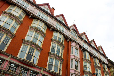 a row of multi - colored buildings on a cloudy day in whitley bay