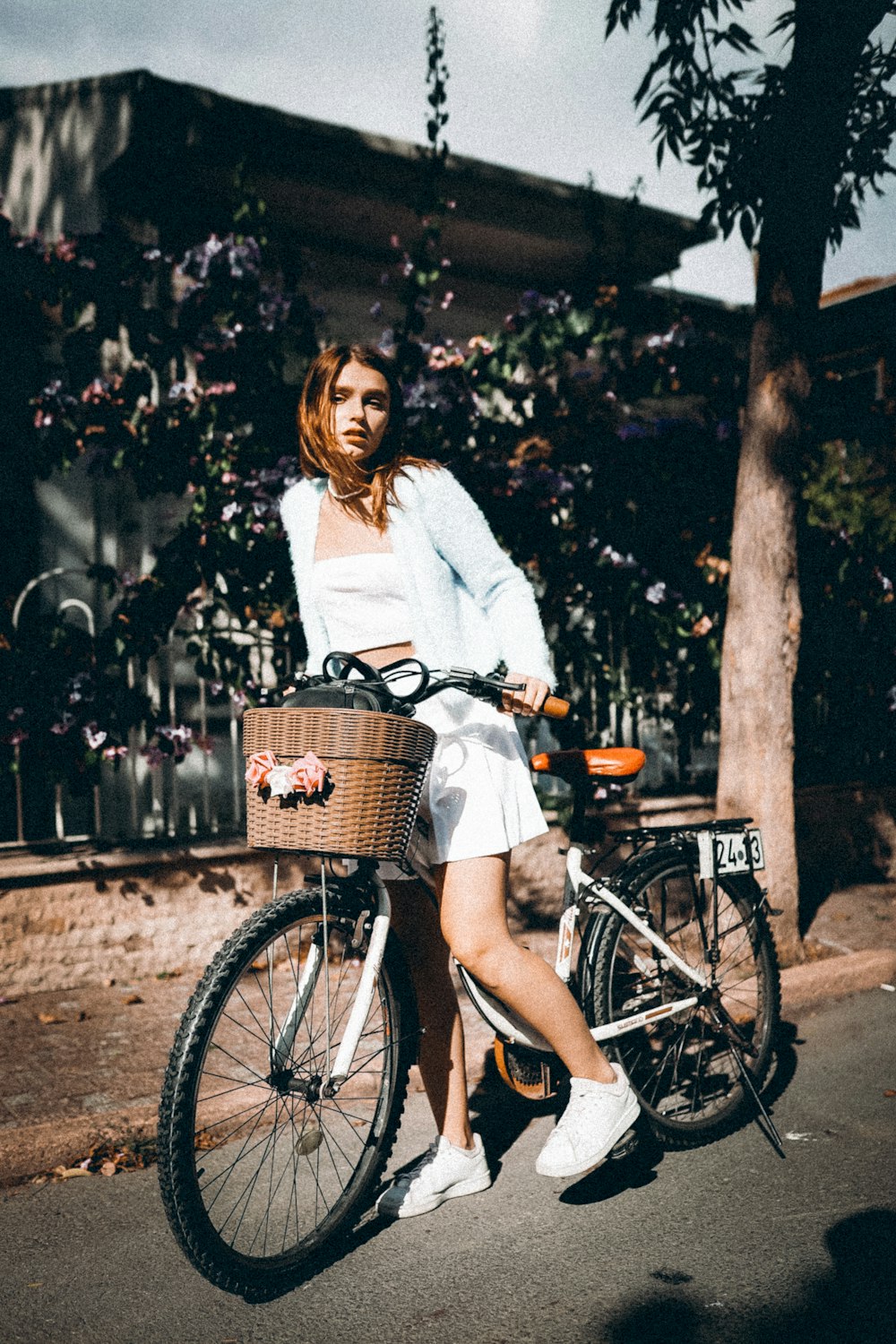 a woman sitting on a bike with a basket