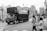 A large truck navigating through a busy city street during the day.