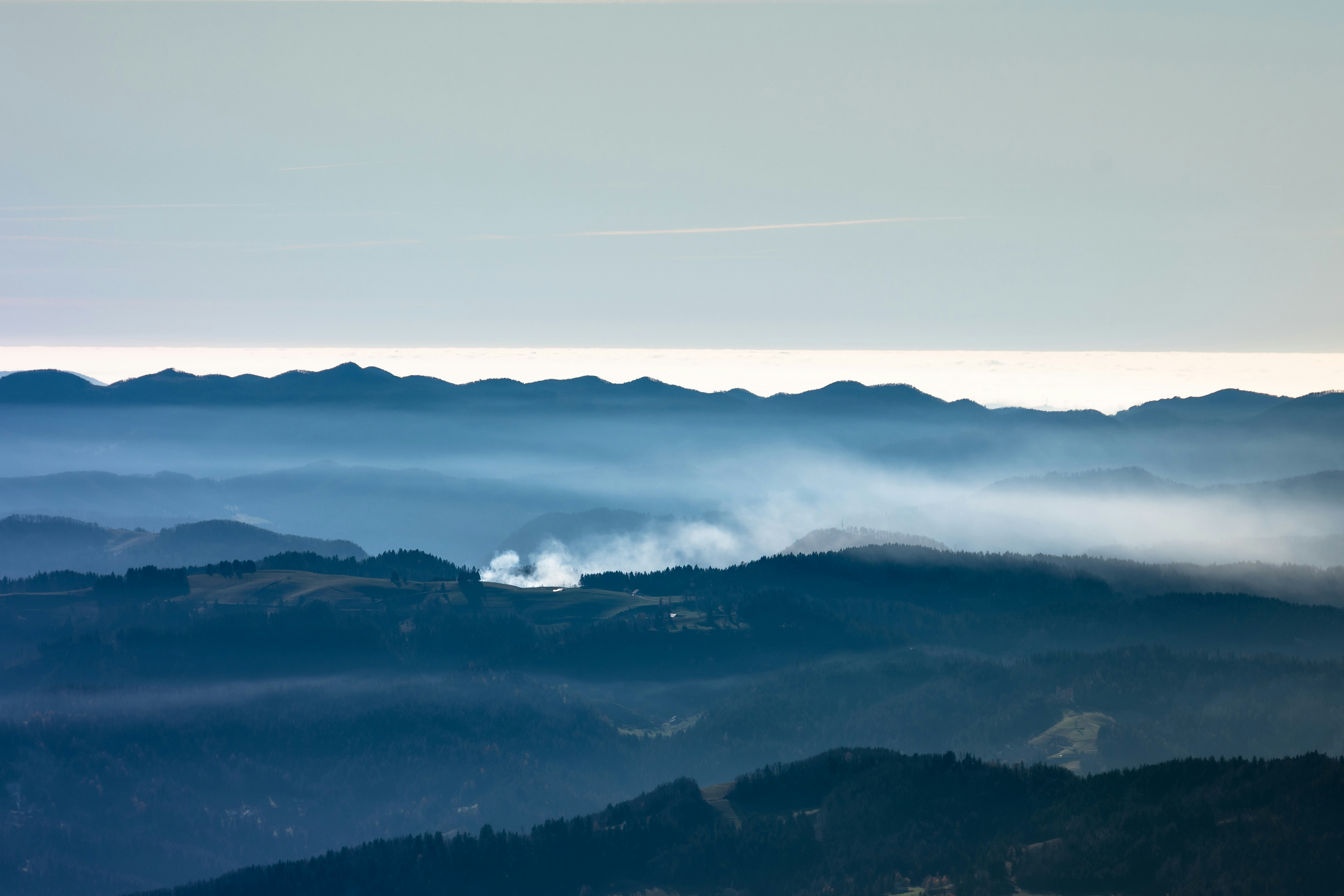 a view of a mountain range covered in fog