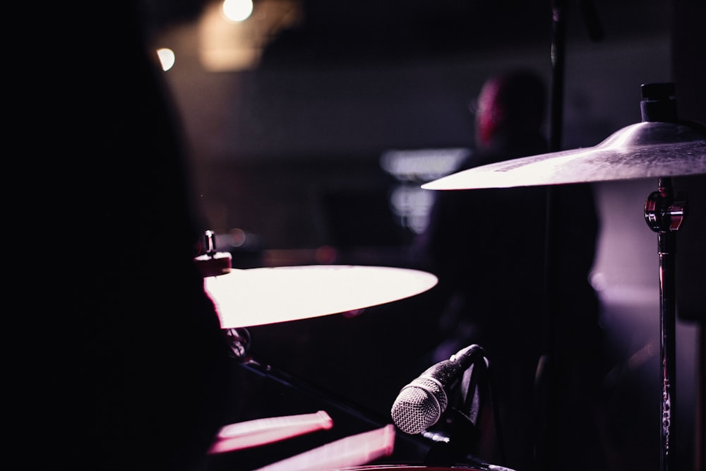 a drum and a microphone in a dark room