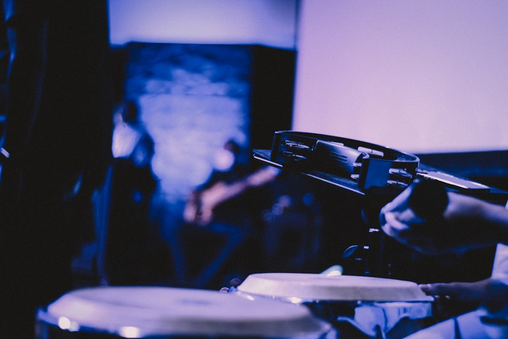 a person playing drums in a dark room