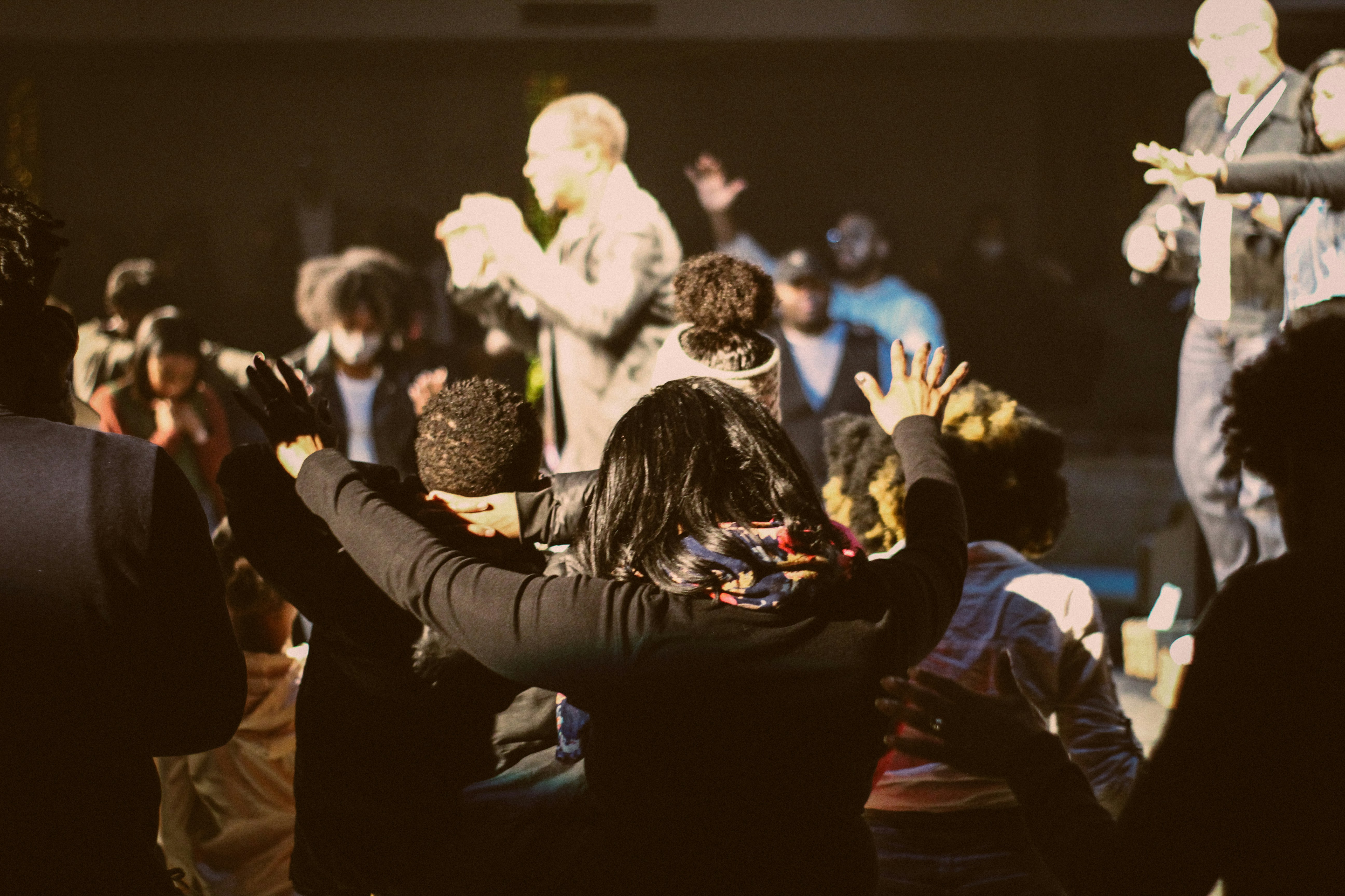 a group of people standing around each other