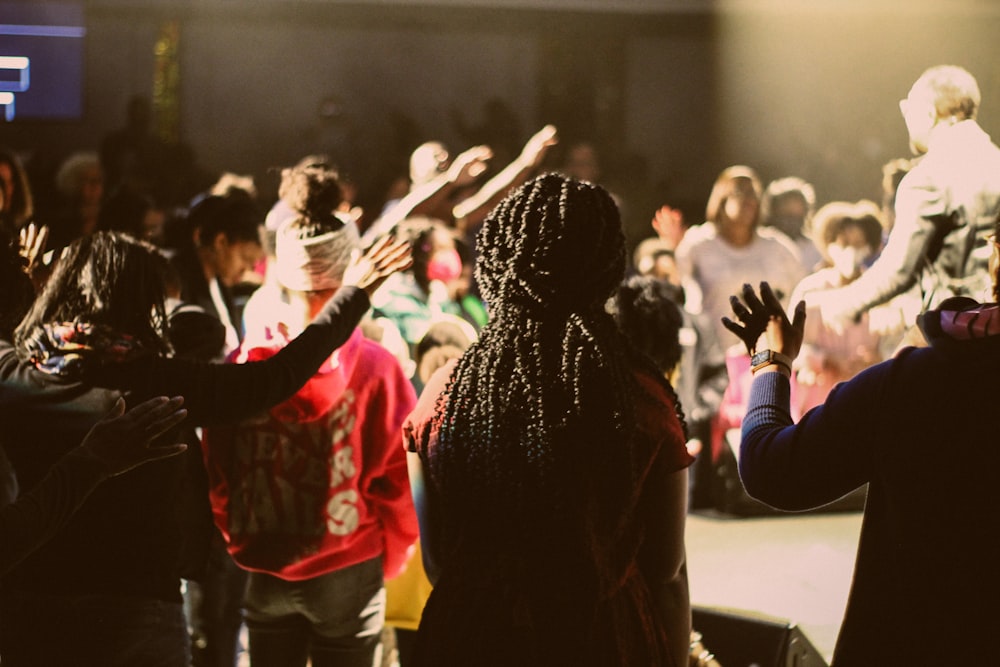 a crowd of people standing around each other