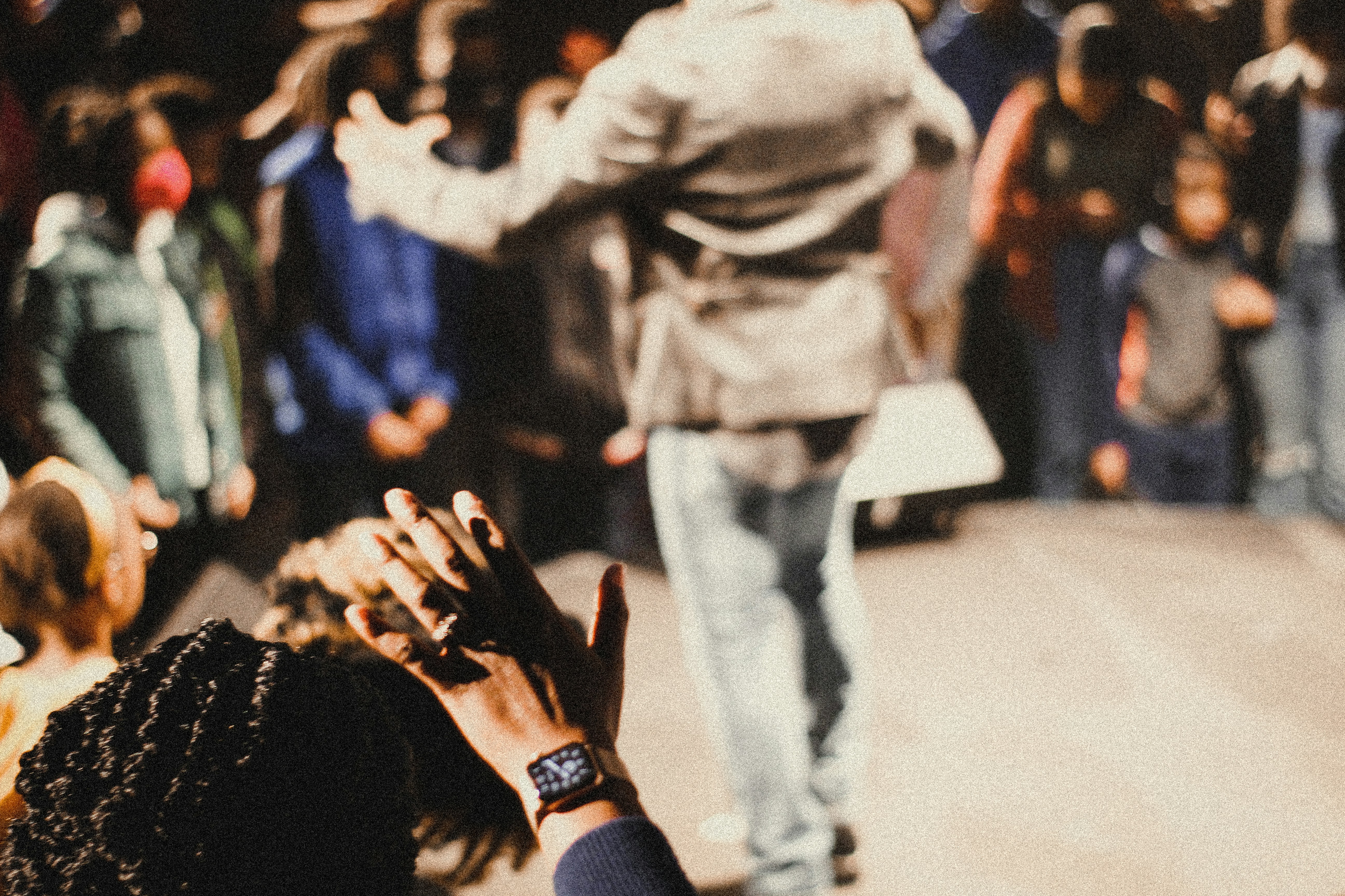 a crowd of people standing around each other