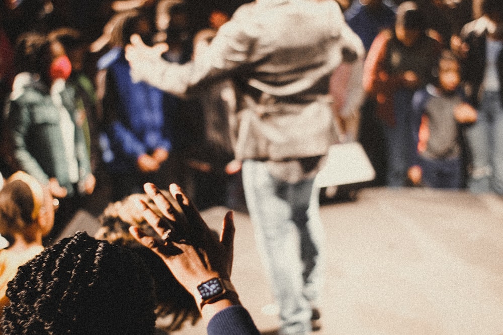 a crowd of people standing around each other