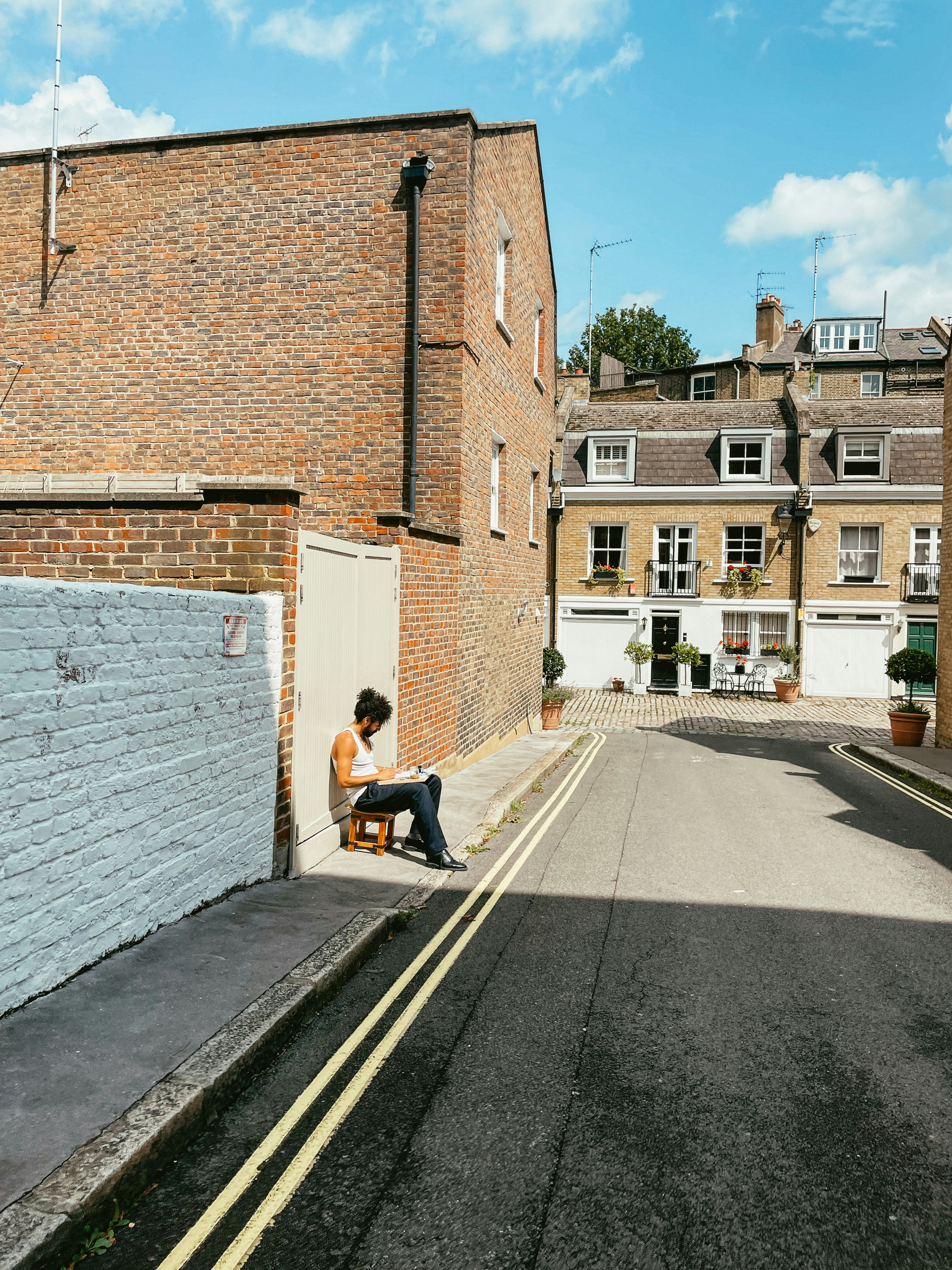 a person sitting on a bench on the side of a road