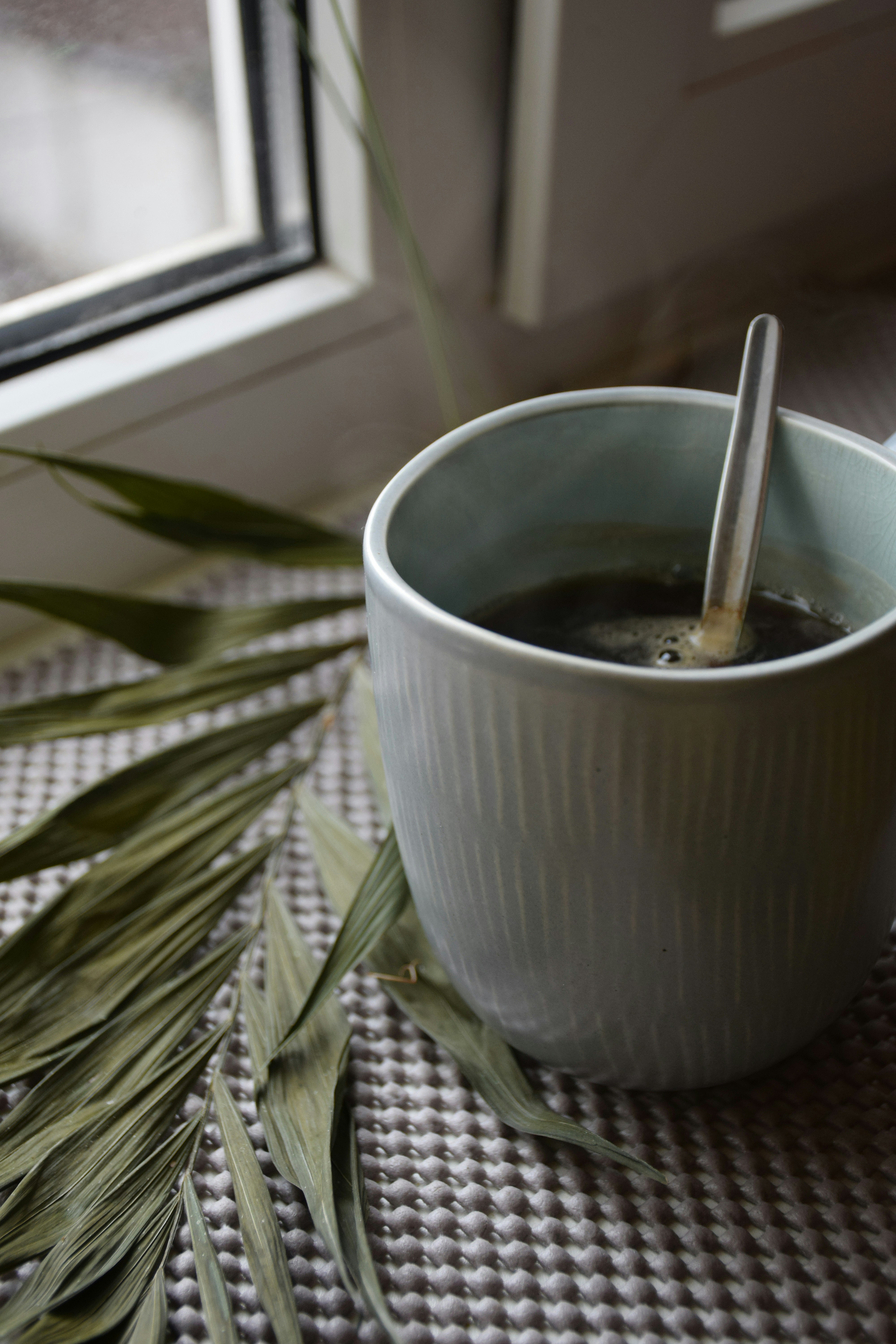a cup of coffee with a spoon in it