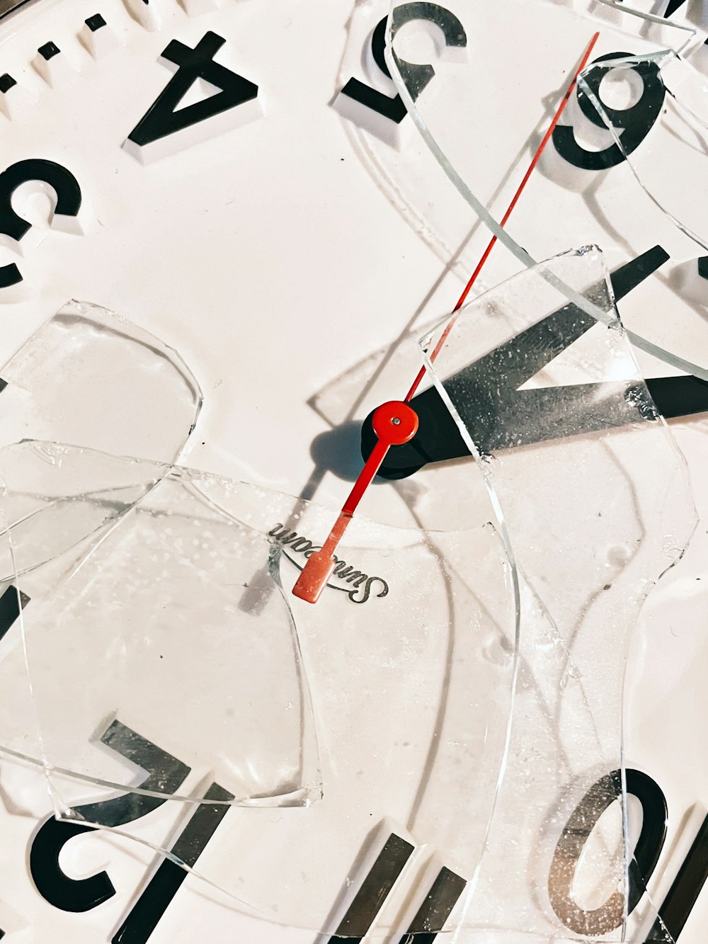 a close up of a clock with a red second hand
