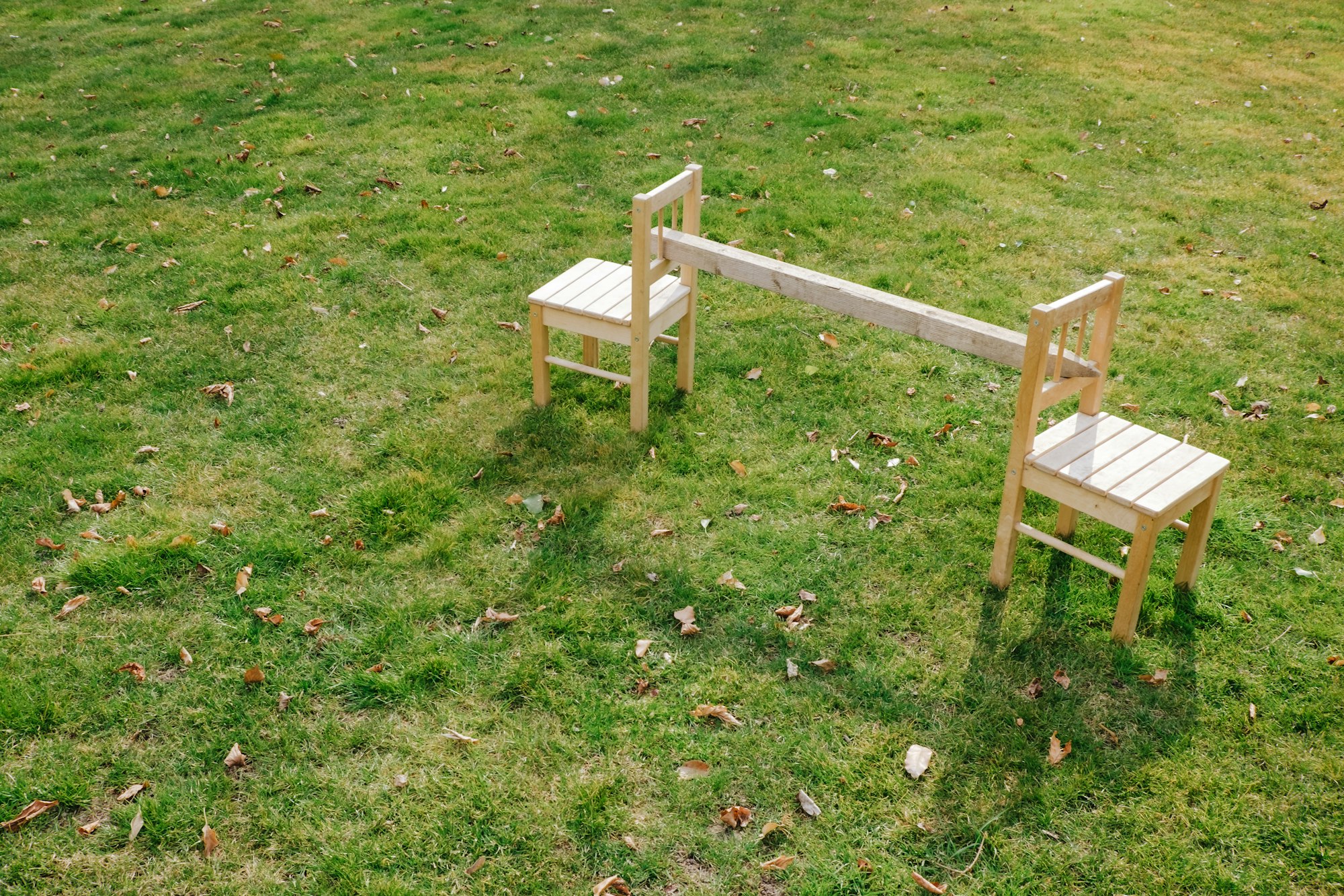 Two chairs in the green grass.