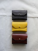 A collection of various wallets arranged neatly on a shelf.