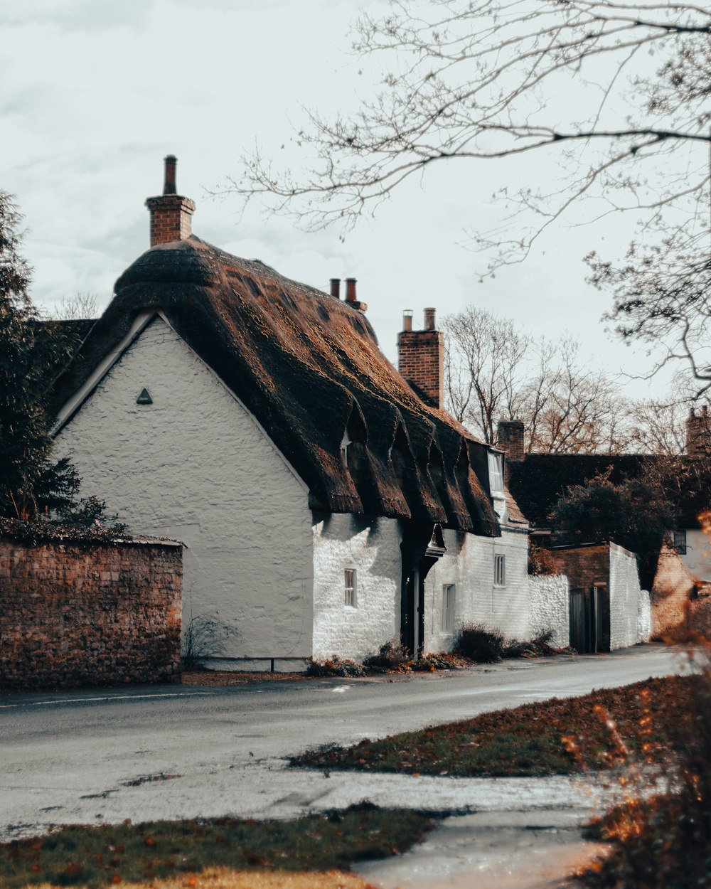 a white house with a thatched roof