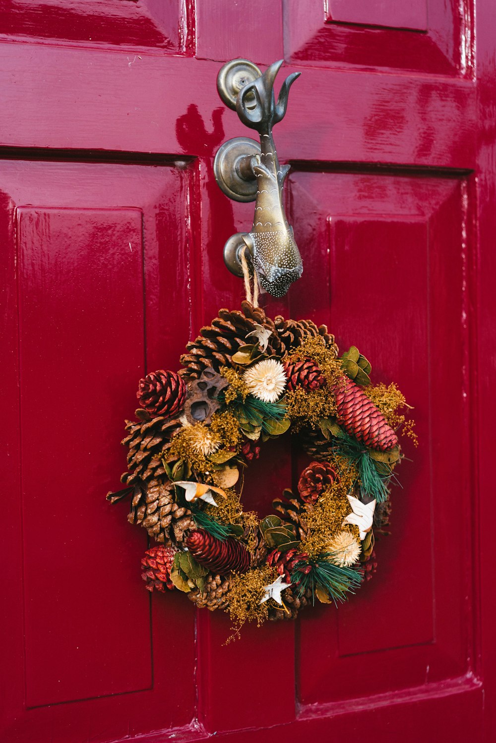 a red door with a wreath hanging on it