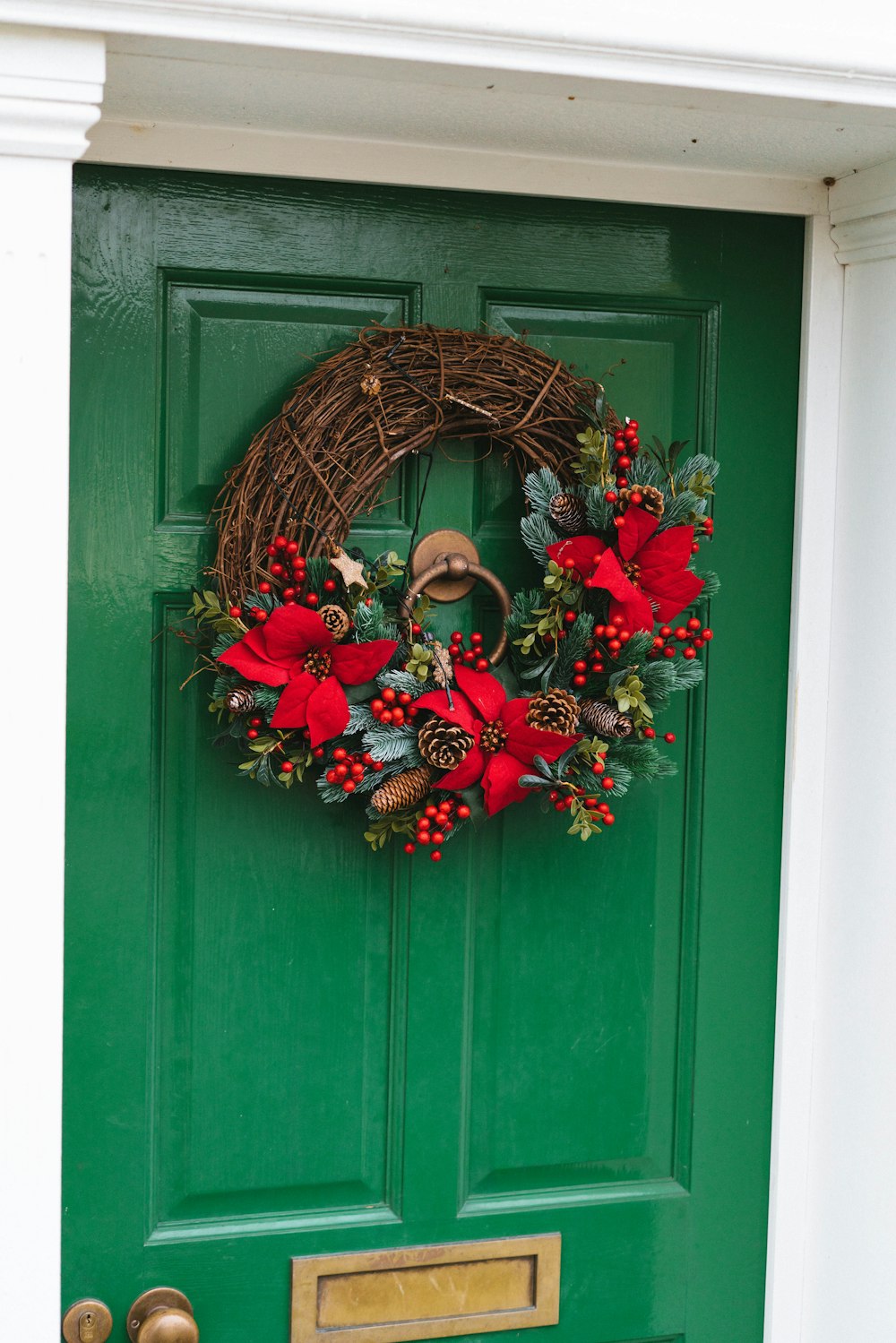 a green door with a wreath on it