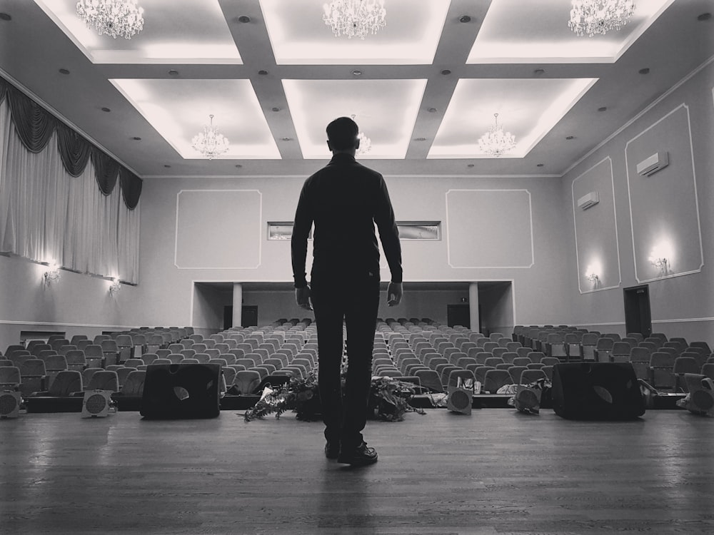 a man standing in front of an empty auditorium