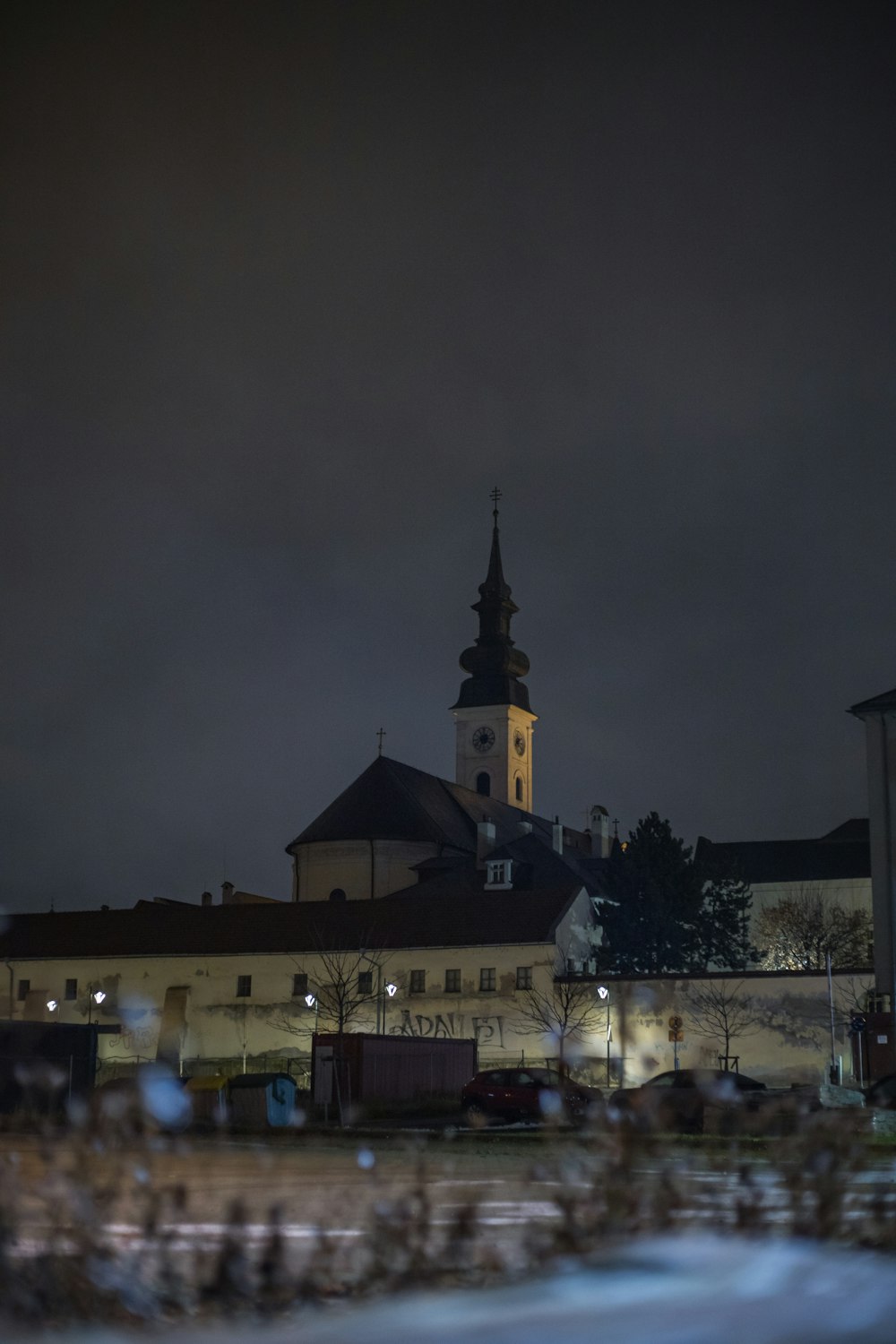 a large building with a clock tower at night