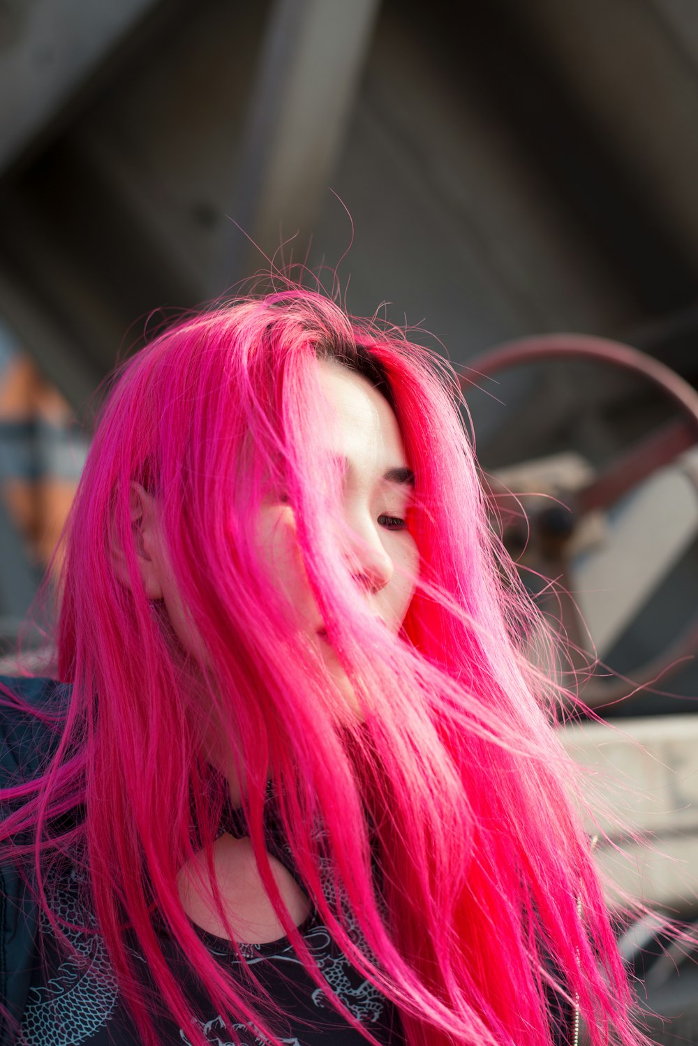 a woman with pink hair and a black shirt