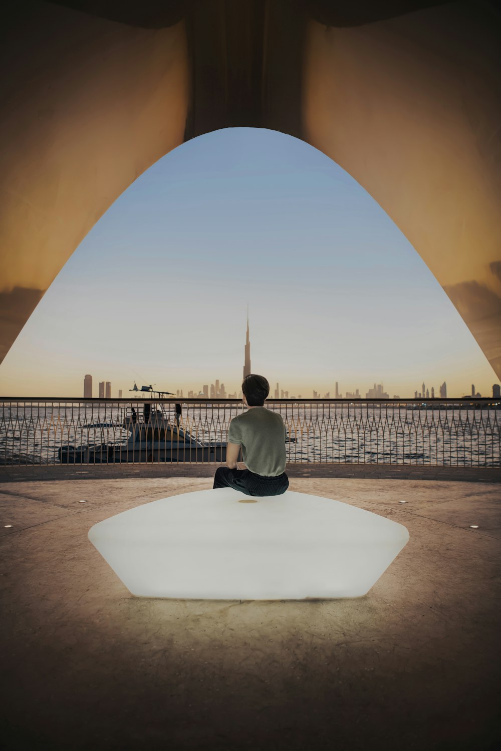 a man sitting on top of a white piece of furniture