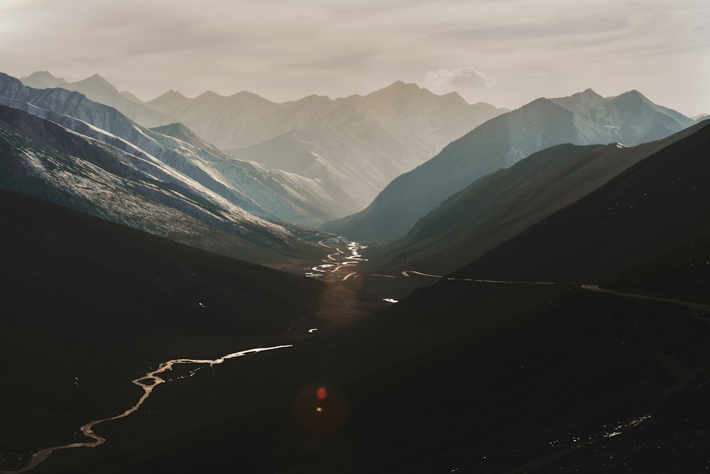 a river running through a valley surrounded by mountains