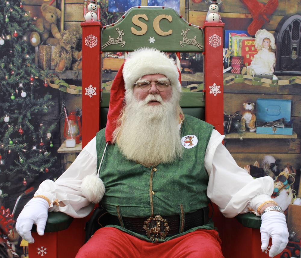 a man dressed as santa claus sitting in a chair