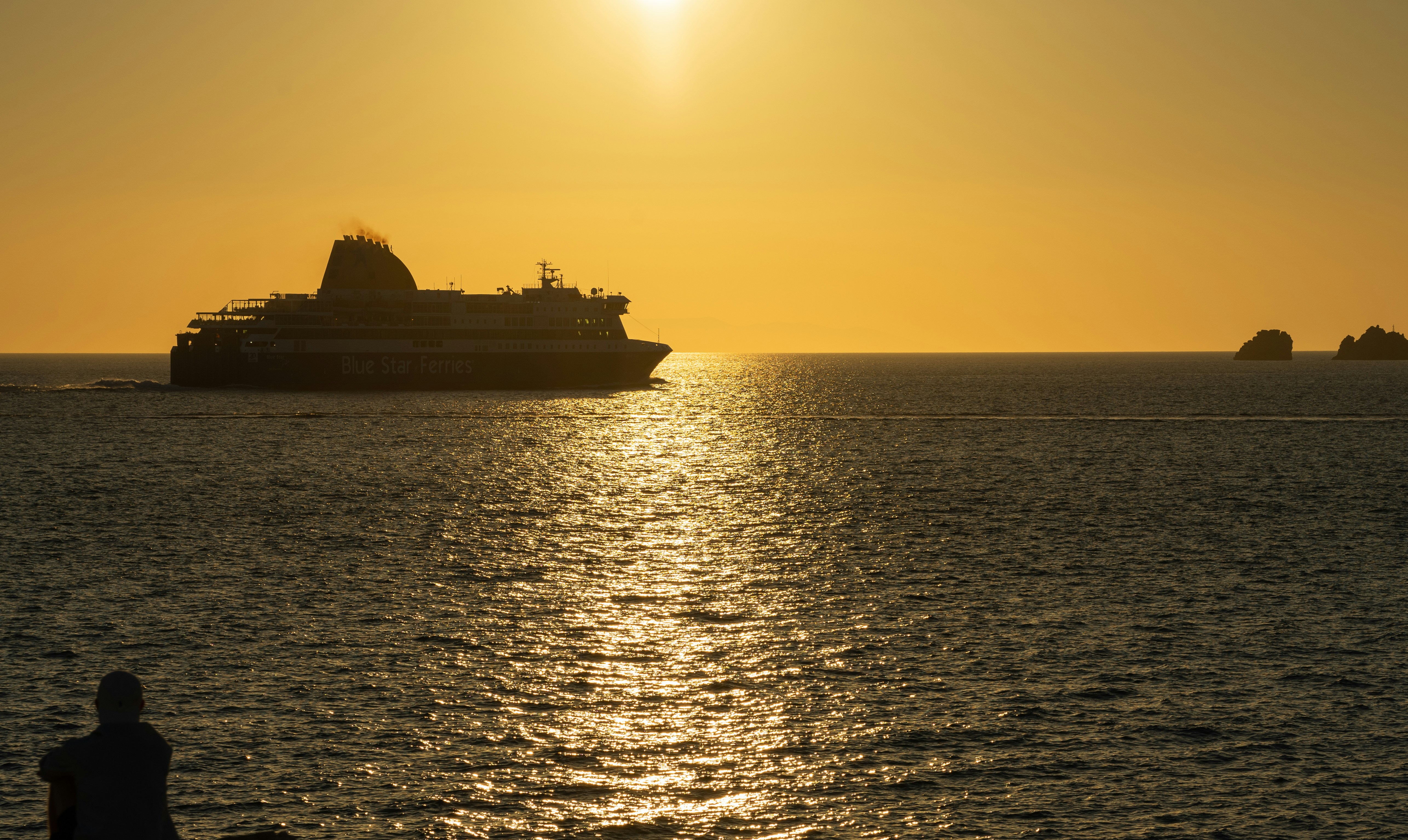 a large boat in the ocean at sunset, 