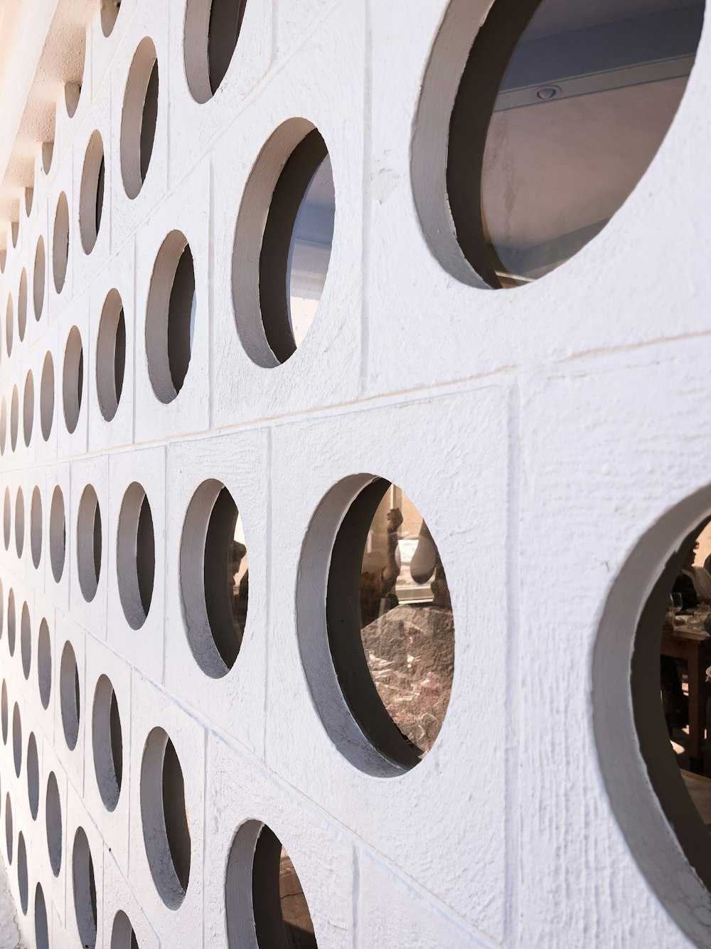 a close up of a white wall with holes in it