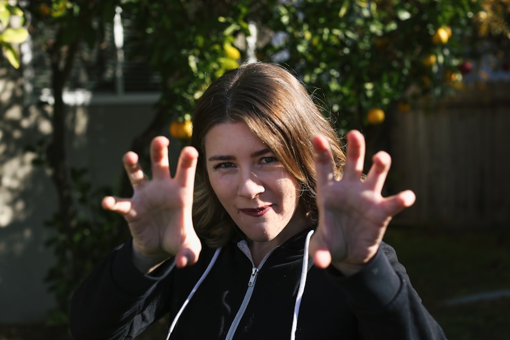 a woman with her hands up in the air