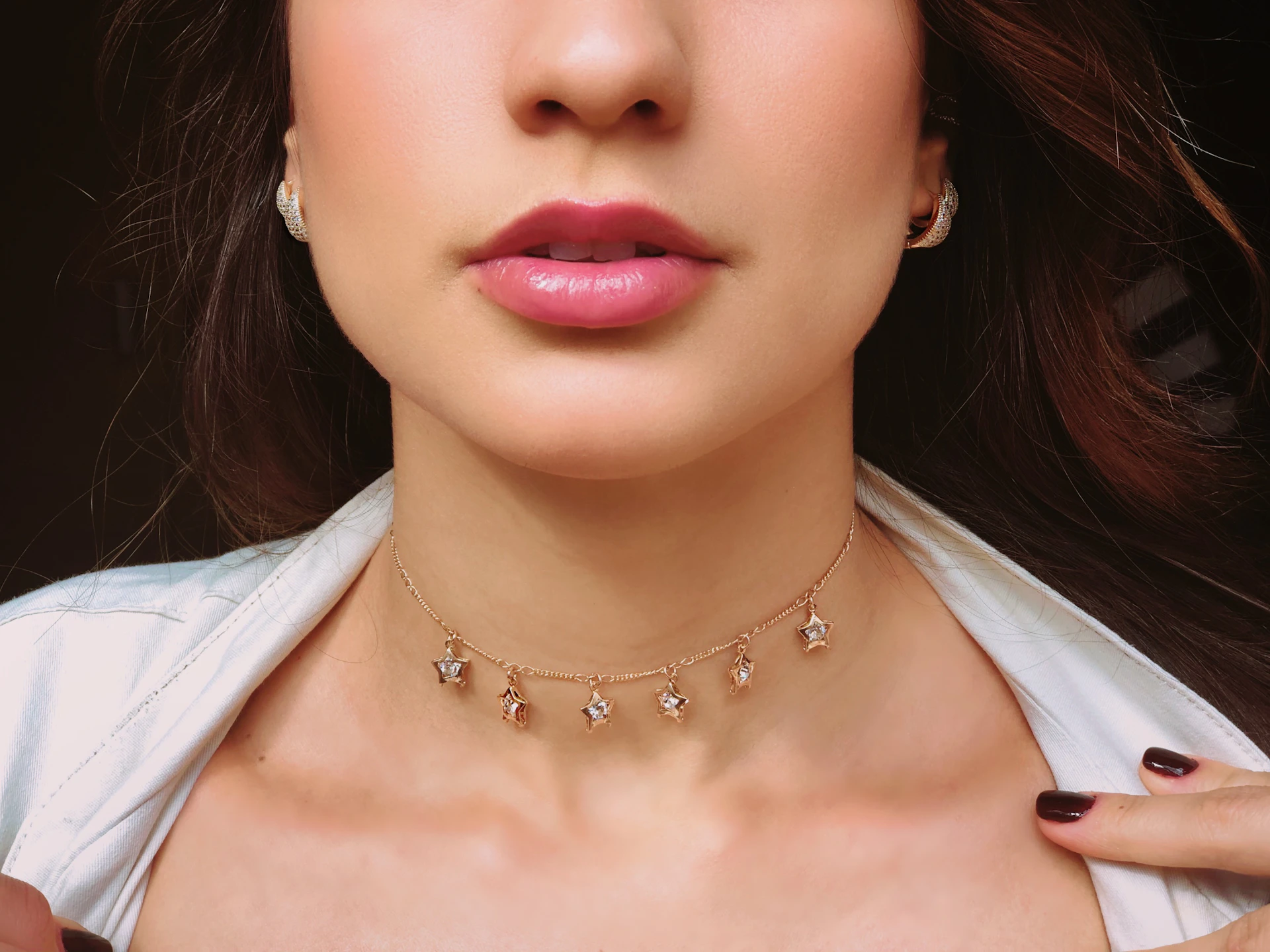a close up of a woman wearing a necklace