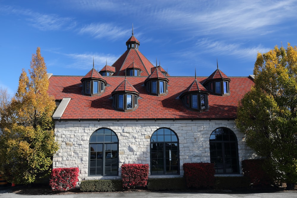 a white brick building with a red roof