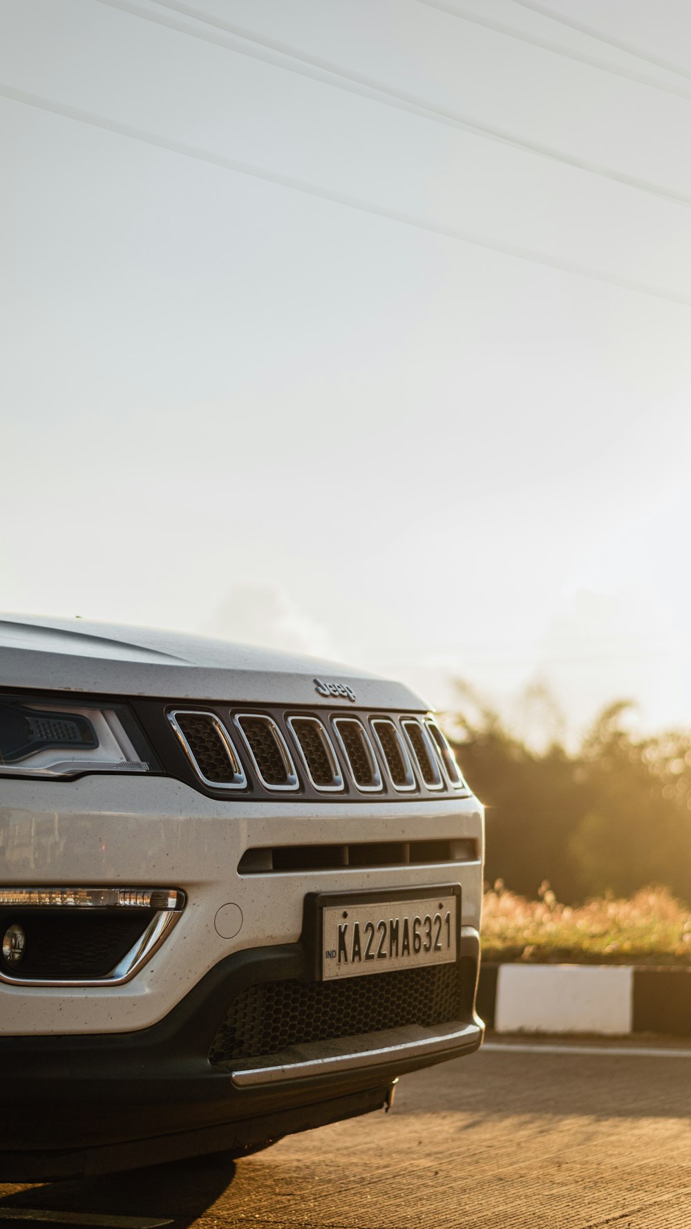 a white jeep parked on the side of the road