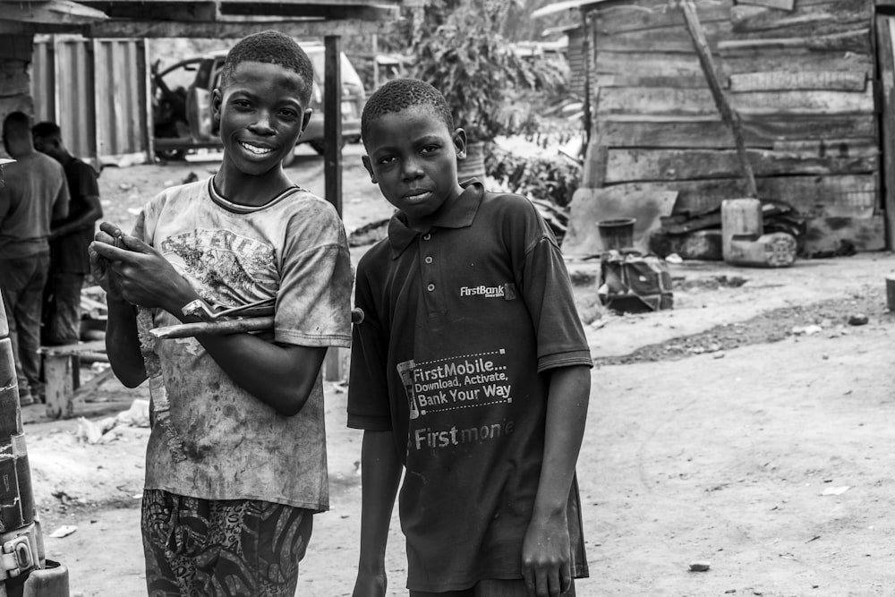 a couple of young boys standing next to each other