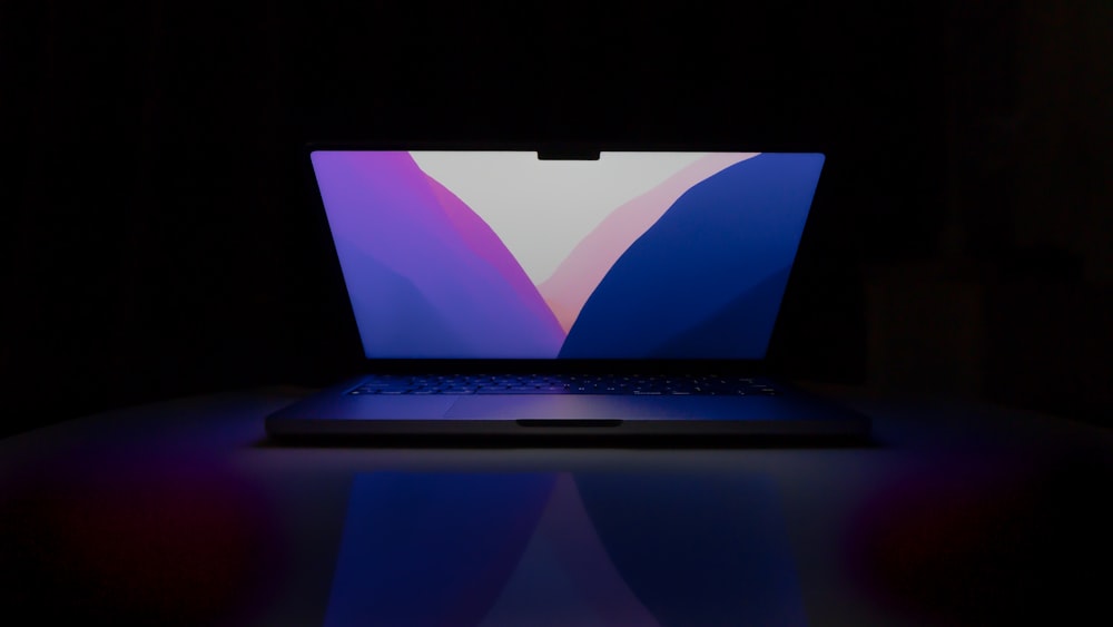 a laptop computer sitting on top of a table