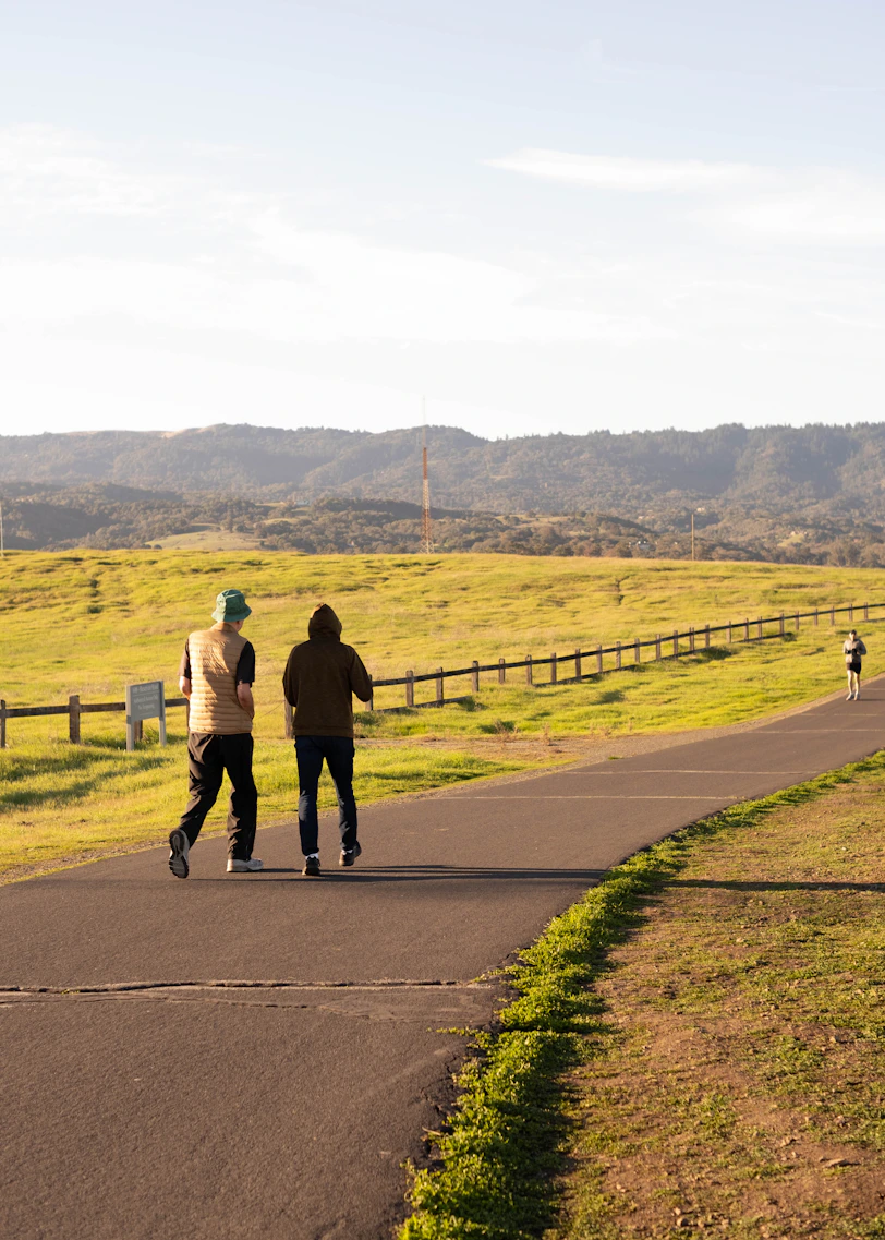 a couple of people riding skateboards down a road