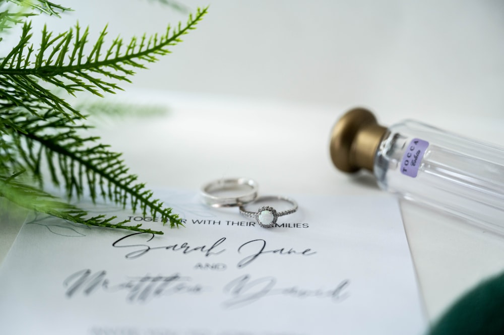 a couple of wedding rings sitting on top of a piece of paper