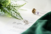 a close up of two wedding rings on top of a paper