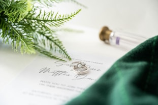 a close up of two wedding rings on top of a paper
