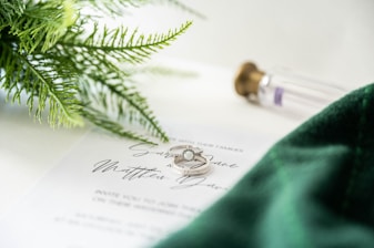 a close up of two wedding rings on top of a paper