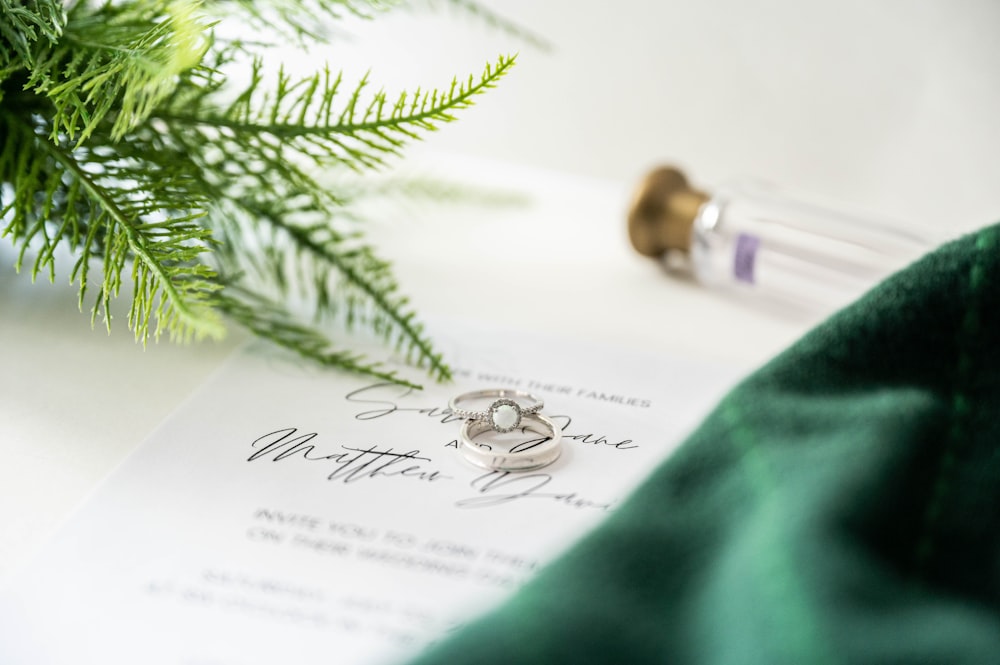 a close up of two wedding rings on top of a paper