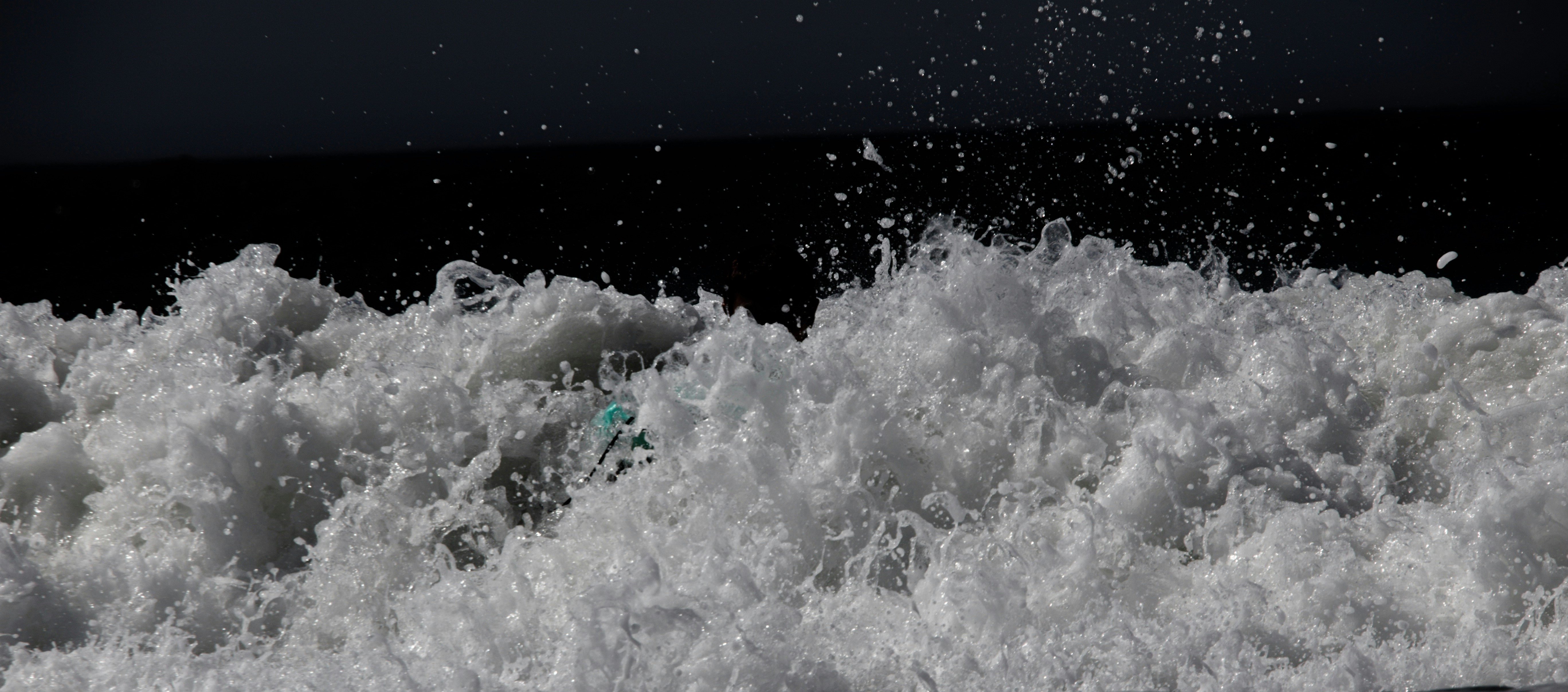 a man riding a wave on top of a surfboard