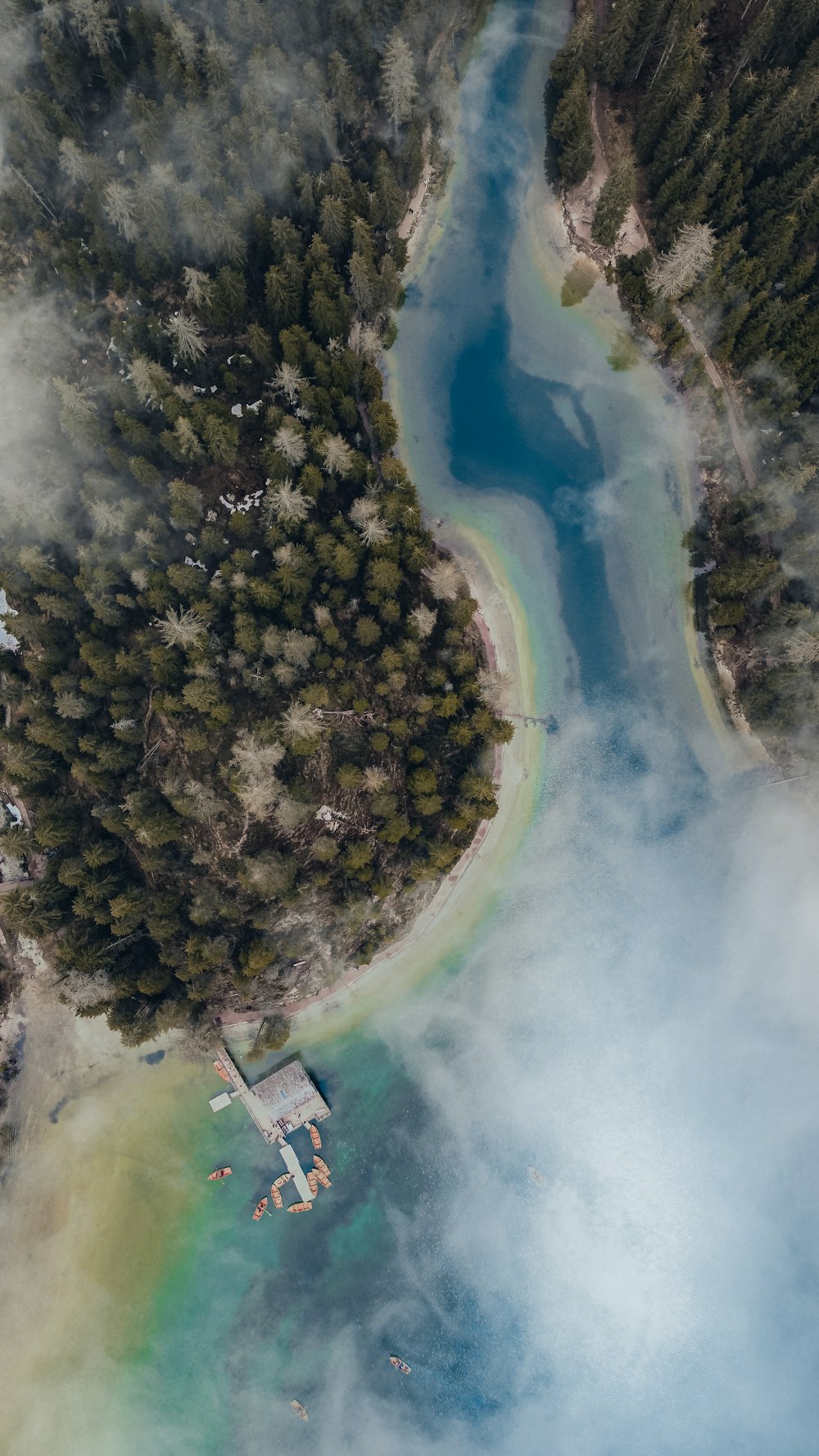 an aerial view of a body of water surrounded by trees