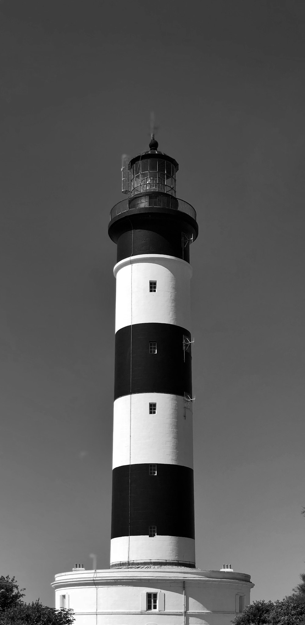 a black and white photo of a lighthouse