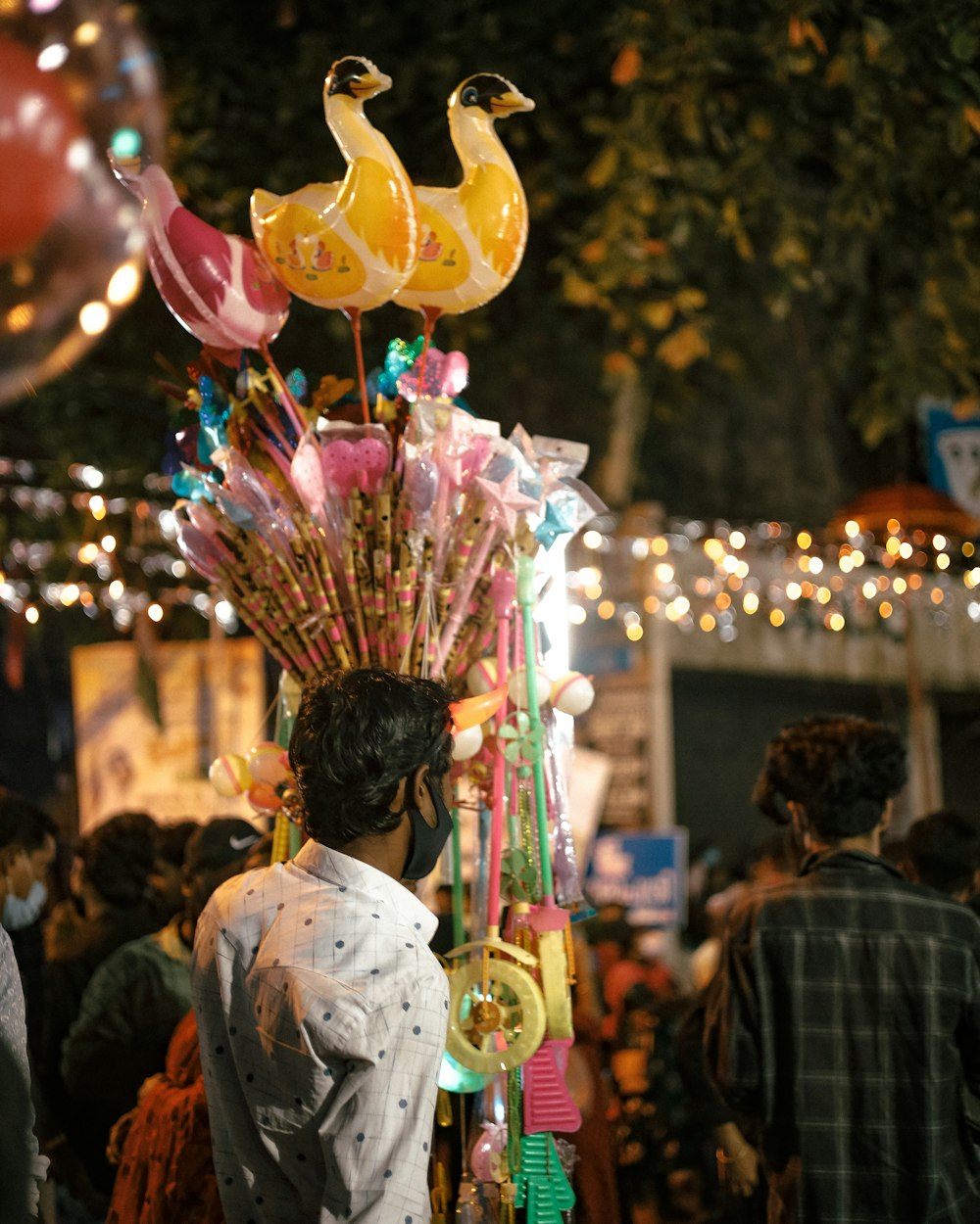 a man with a bunch of balloons on his head