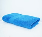 a blue towel sitting on top of a white table