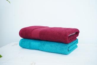 a stack of three towels sitting on top of a table
