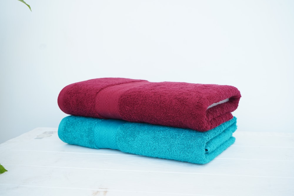 a stack of three towels sitting on top of a table