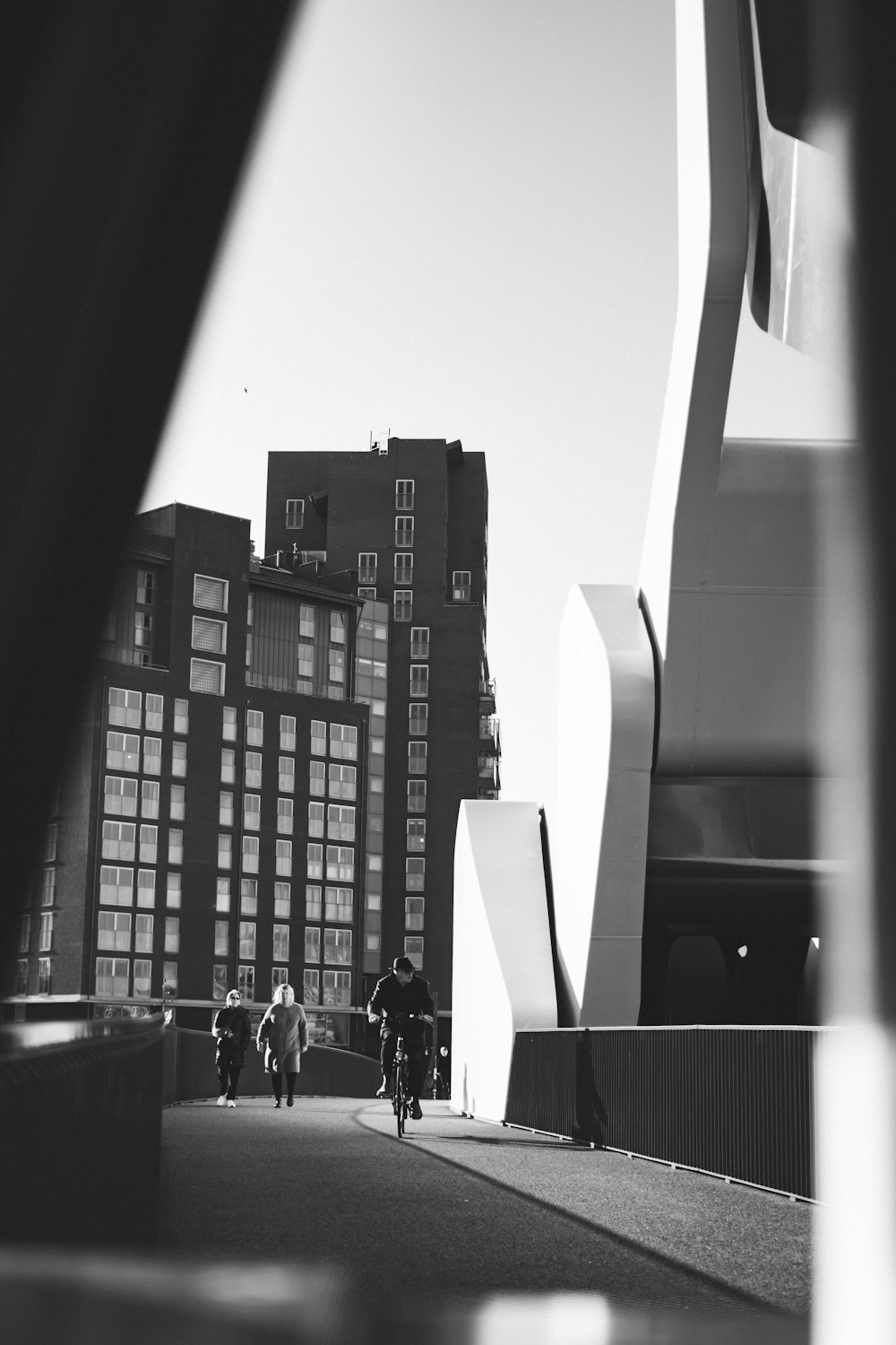 a black and white photo of people riding bikes