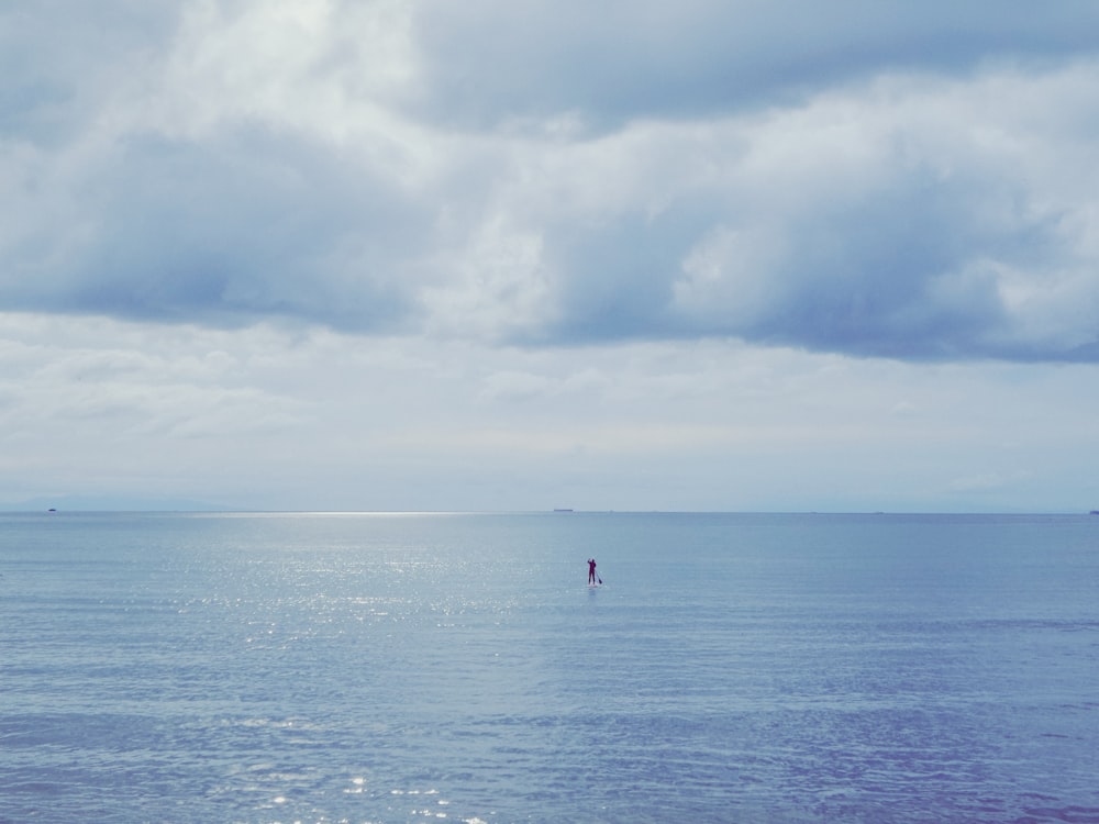 a lone boat in the middle of a large body of water