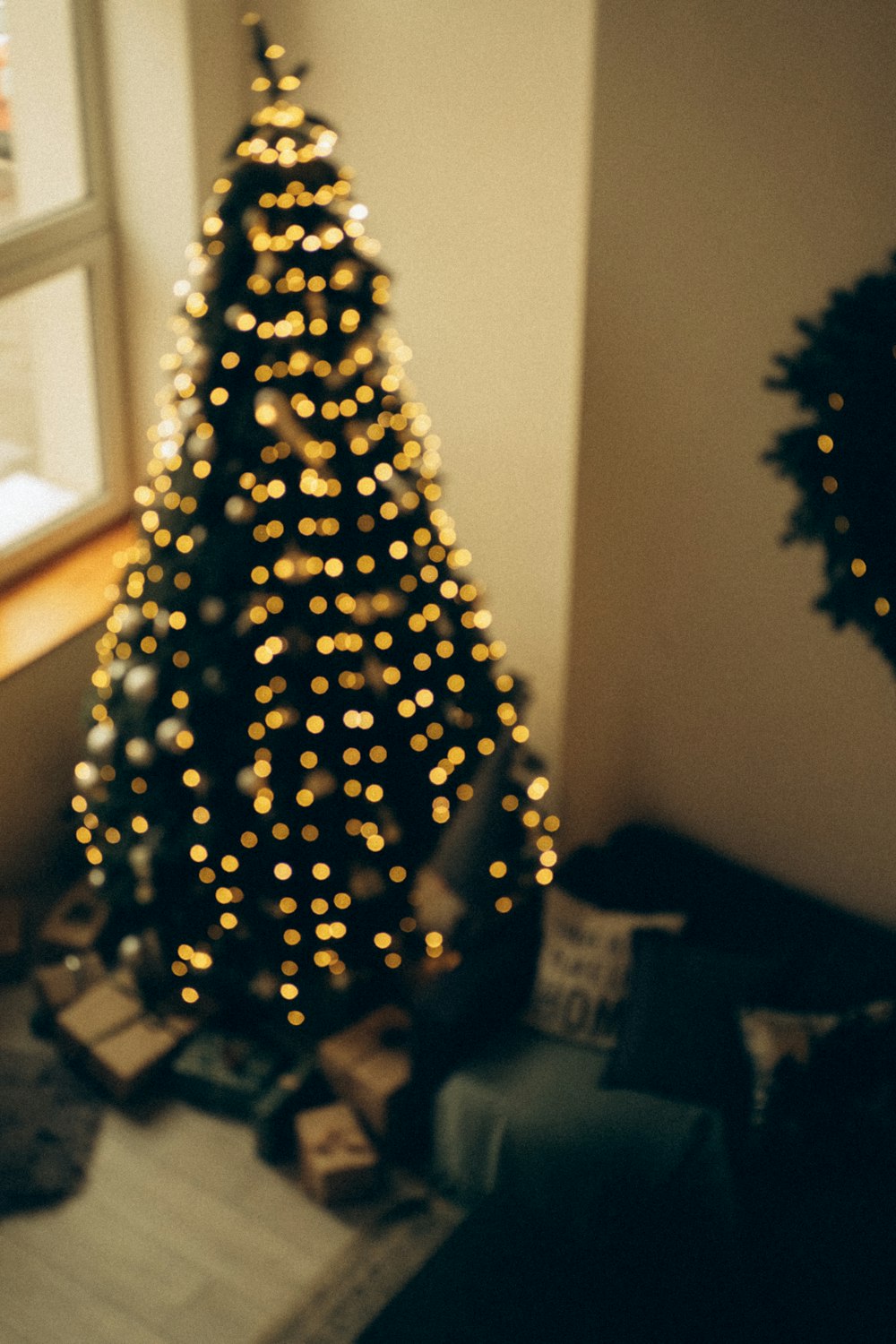 a small christmas tree in a corner of a room