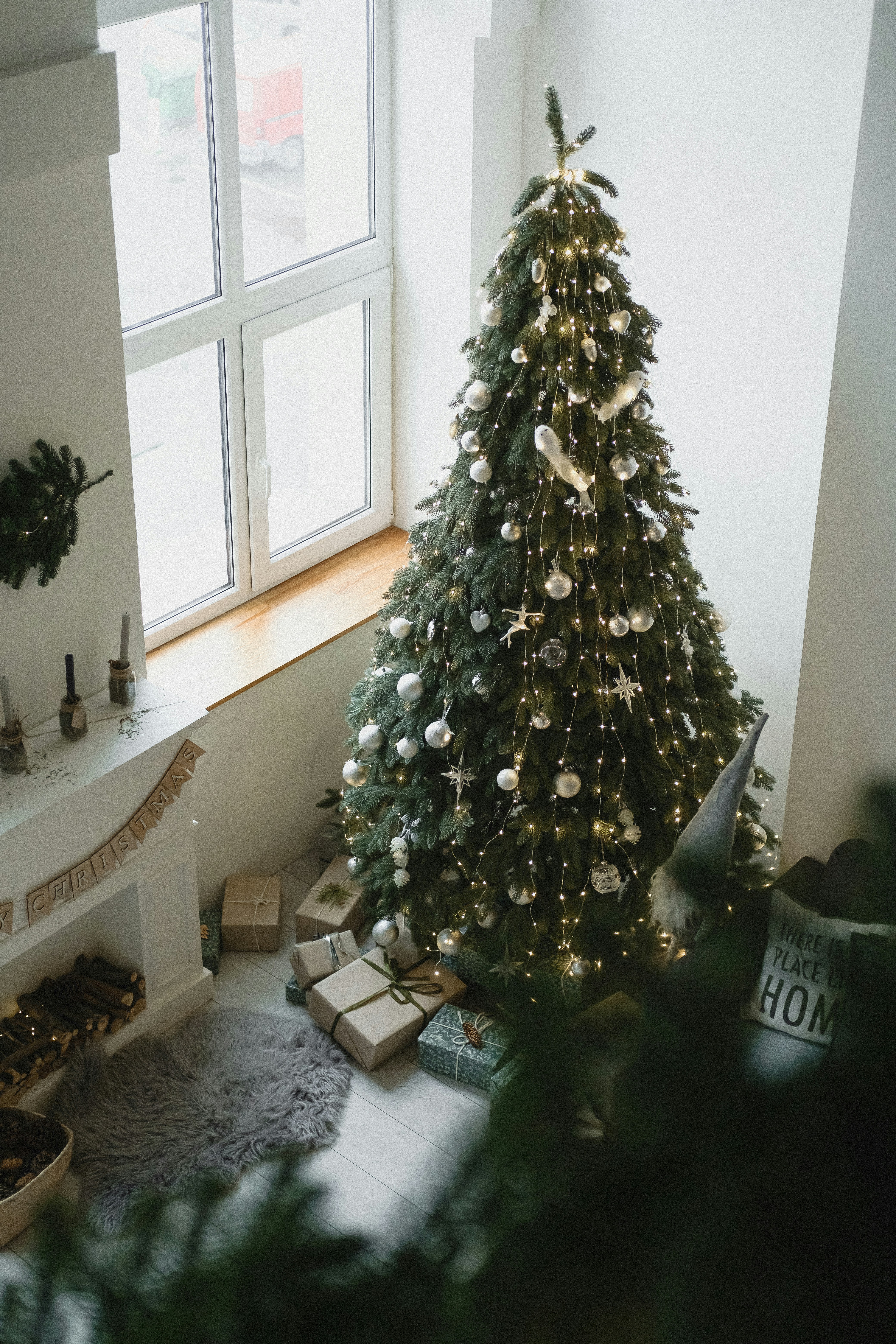 a decorated christmas tree in front of a window