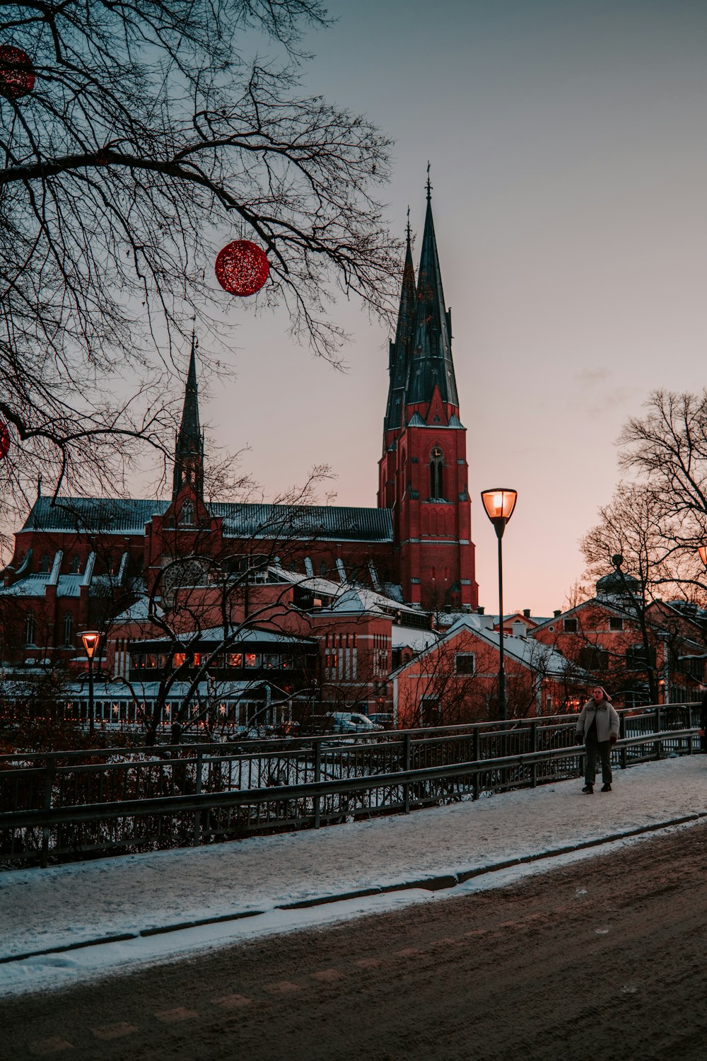 a person walking down a street in front of a church